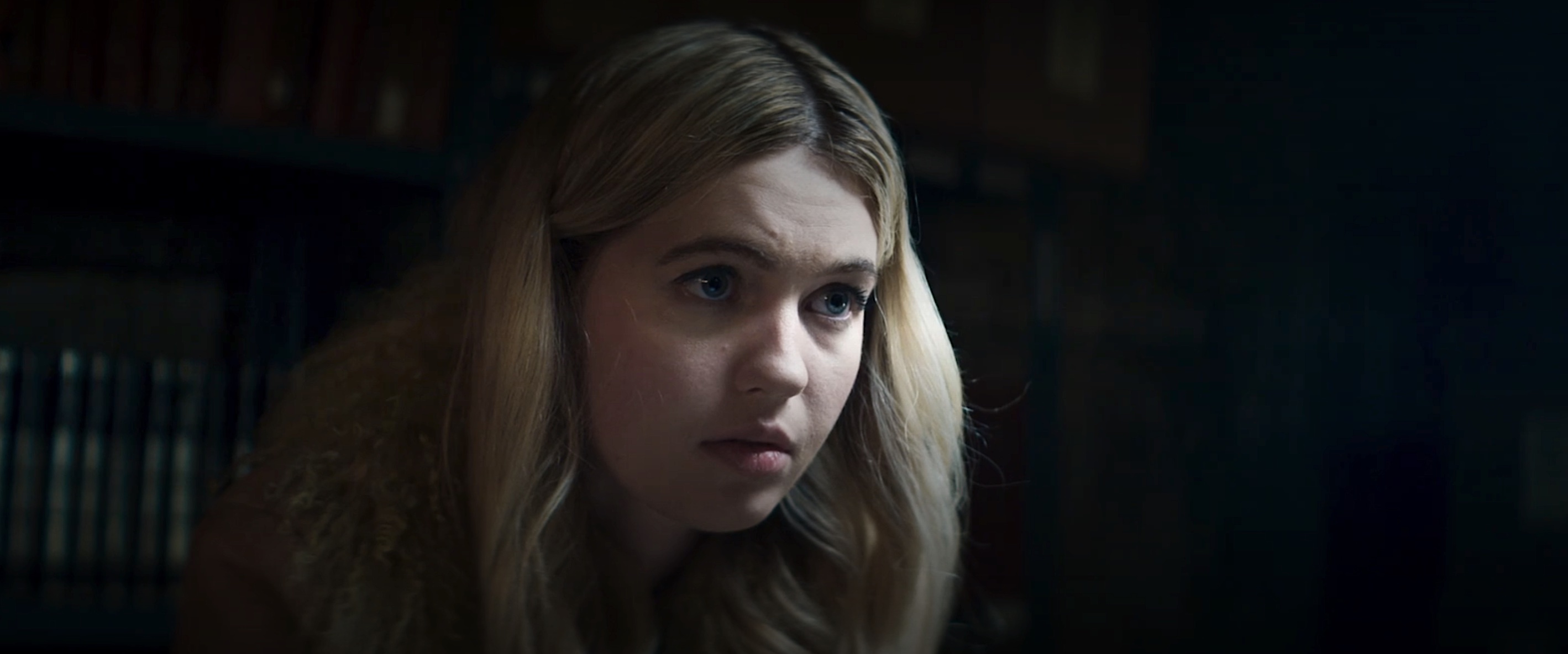 Maisie (Olivia Scott Welch), a 20-something blonde woman seen in extreme closeup, looking nervous in The Sacrifice Game
