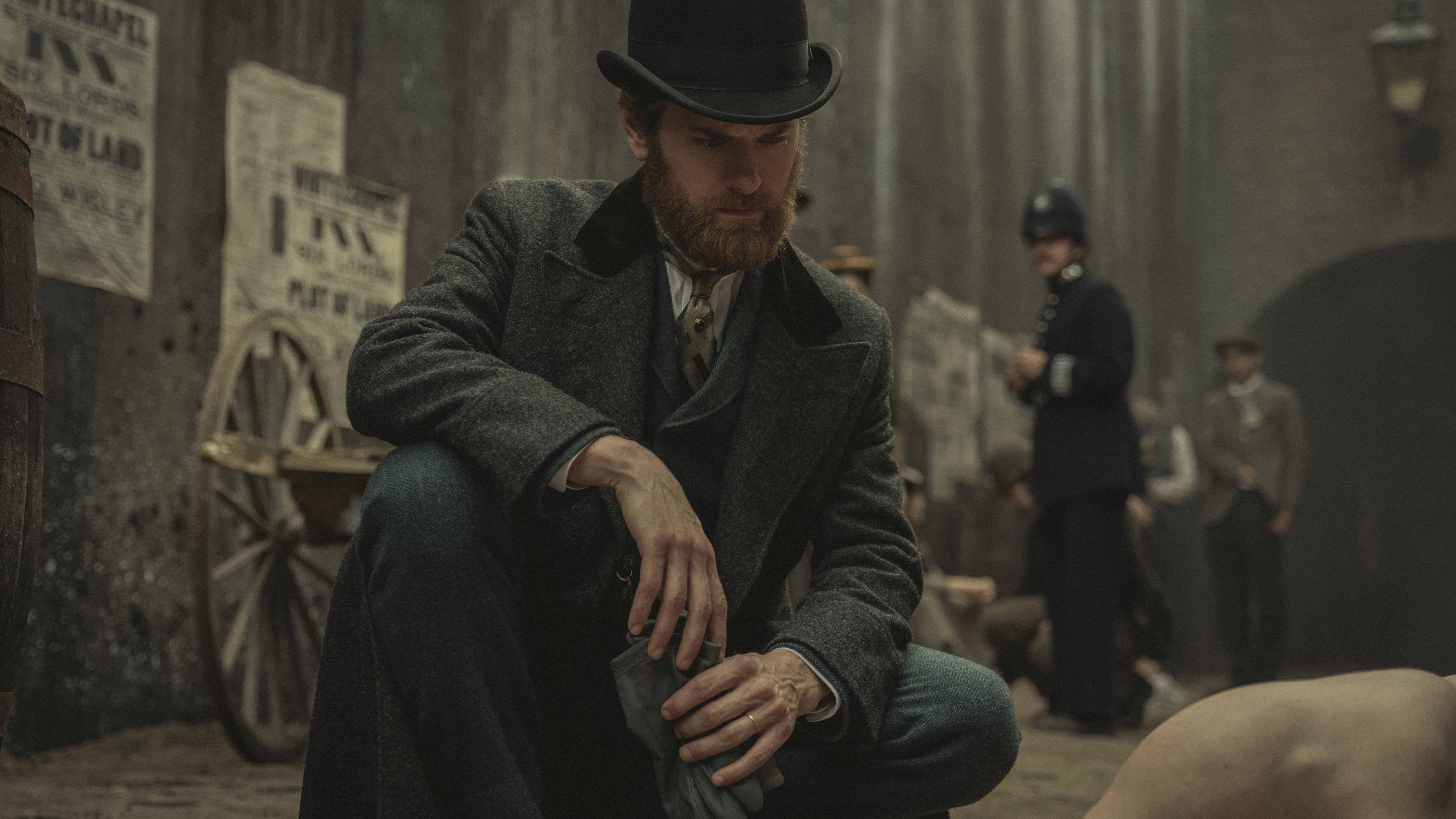 Kyle Soller as Detective Inspector Alfred Hillinghead kneeling beside a dead body in Bodies.