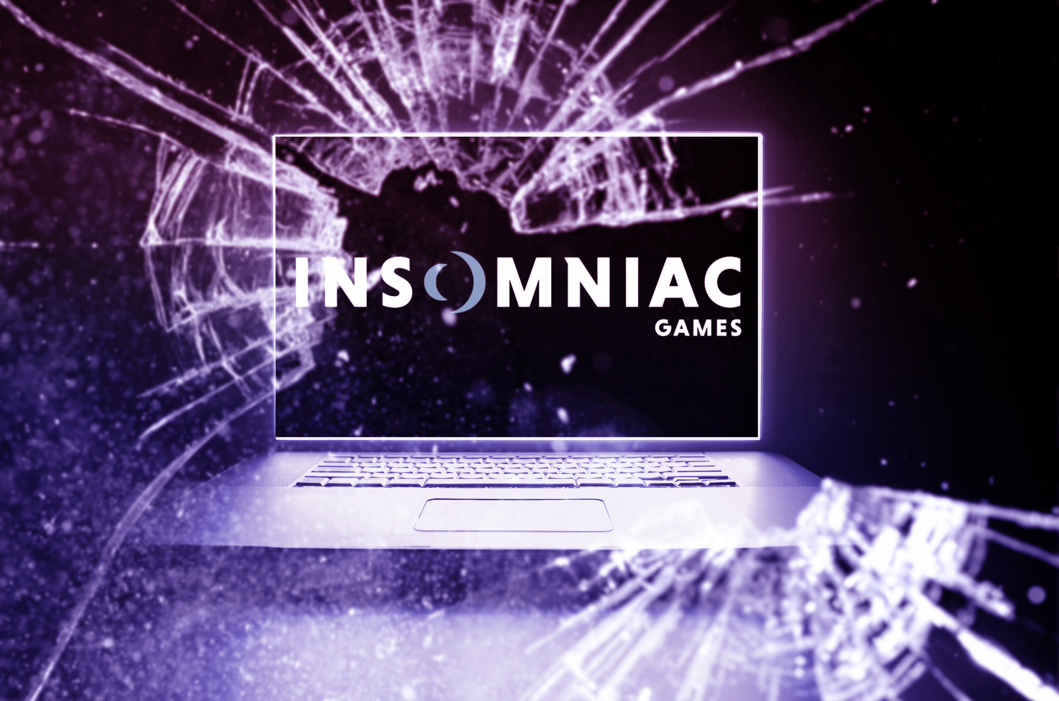 A photo illustration of a laptop with a screen that reads “Insomniac Games.” The glass in front appears broken.