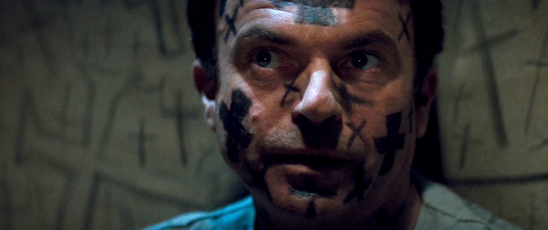 Sam Neill is having a very bad time in In the Mouth of Madness, with crosses sharpied on his face.