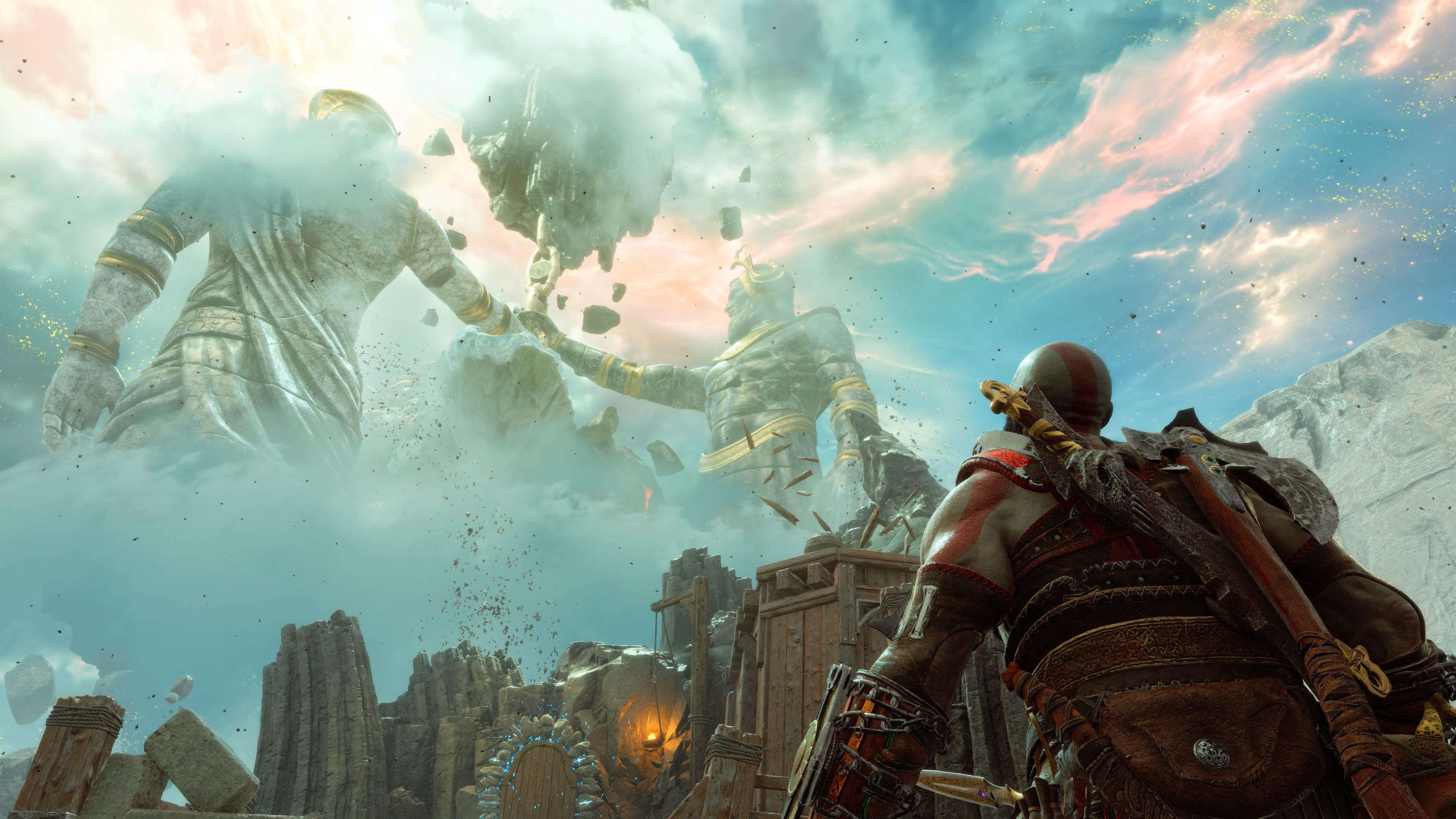 Kratos glances up at massive statues in the distance in God of War Ragnarök: Valhalla