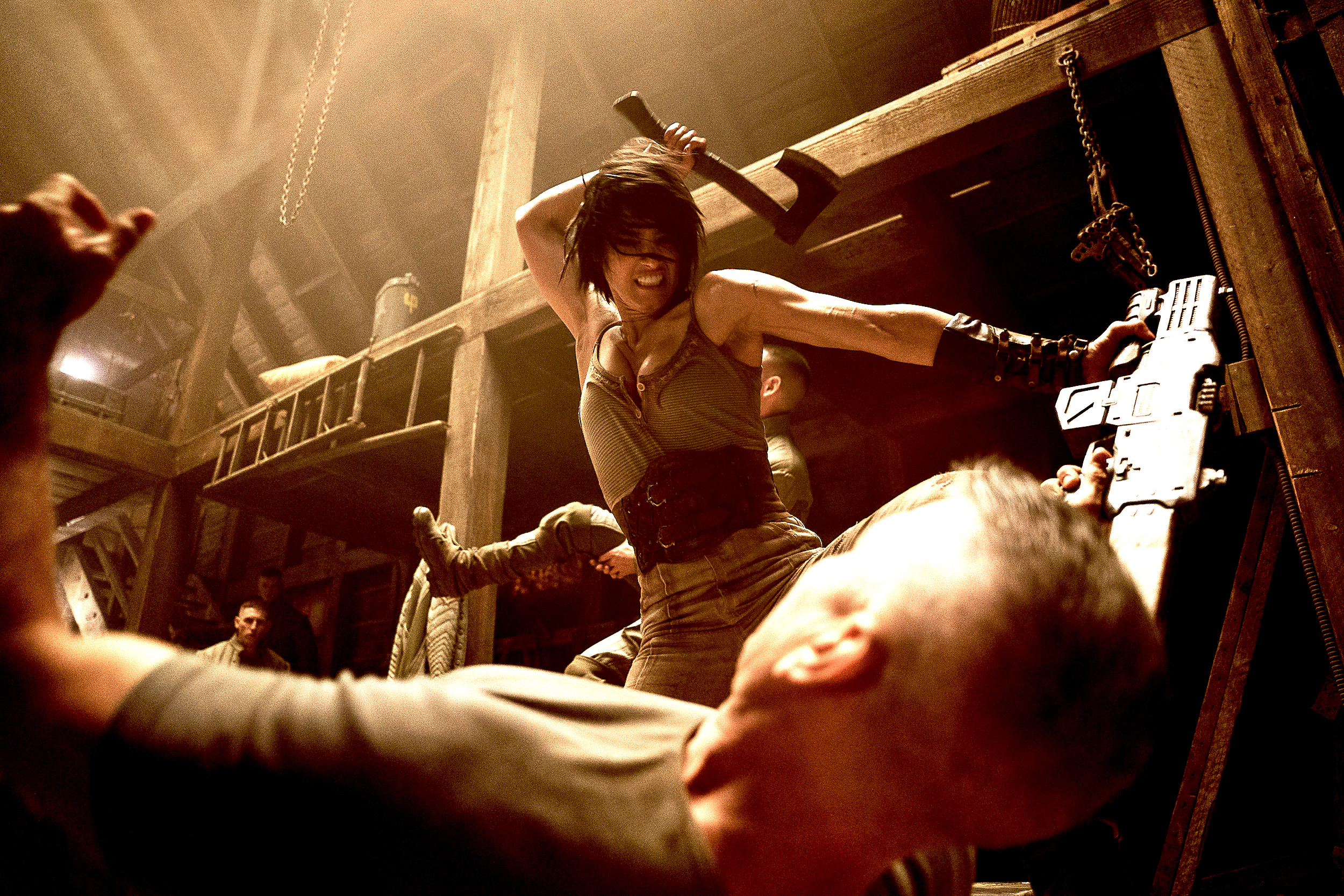 Kora (Sofia Boutella) swings an axe above a floored soldier in Rebel Moon Part One - A Child of Fire